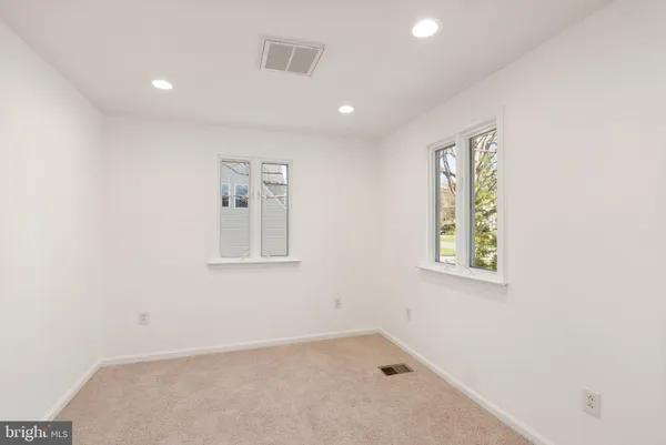 a view of a big yard with large trees