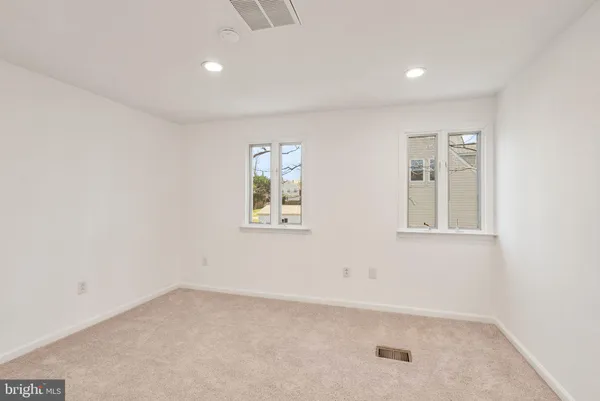 a view of a house with backyard and a tree