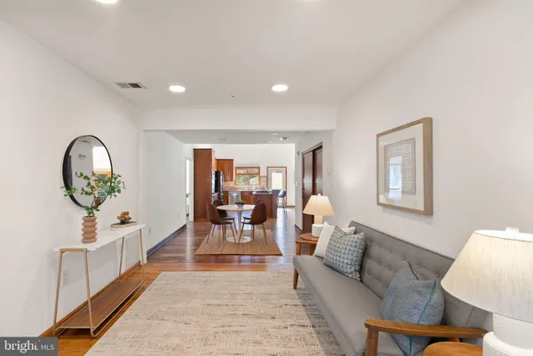 a bedroom with furniture and a wooden floor