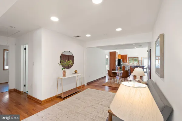 a living room with furniture and a wooden floor