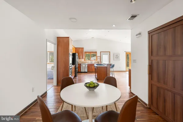 a kitchen with stainless steel appliances granite countertop a stove and a wooden cabinets