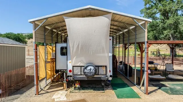 a view of a brick house with many windows next to a road