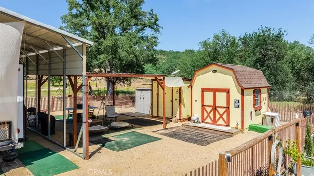 a view of a patio with table and chairs under an umbrella