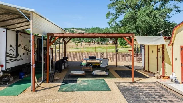 a view of a house with backyard and sitting area