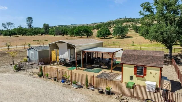 an aerial view of a house with a yard and lake view