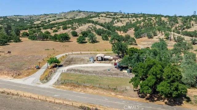 an aerial view of a house with a yard and lake view