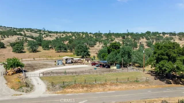 a view of a swimming pool with lawn chairs under an umbrella