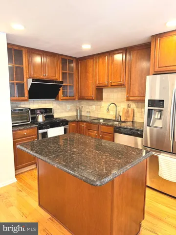 a view of a kitchen and a window in a room