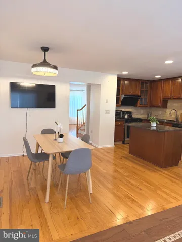 a kitchen with stainless steel appliances granite countertop a sink a stove window and cabinets