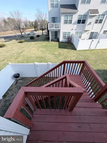 a view of a balcony with wooden floor and outdoor seating