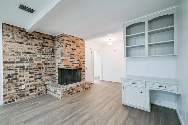 a living room with a fireplace furniture a rug and a fireplace