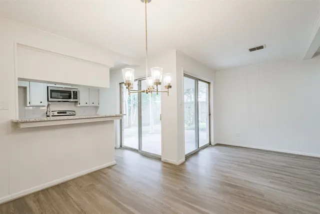 a kitchen with stainless steel appliances a refrigerator and a stove top oven