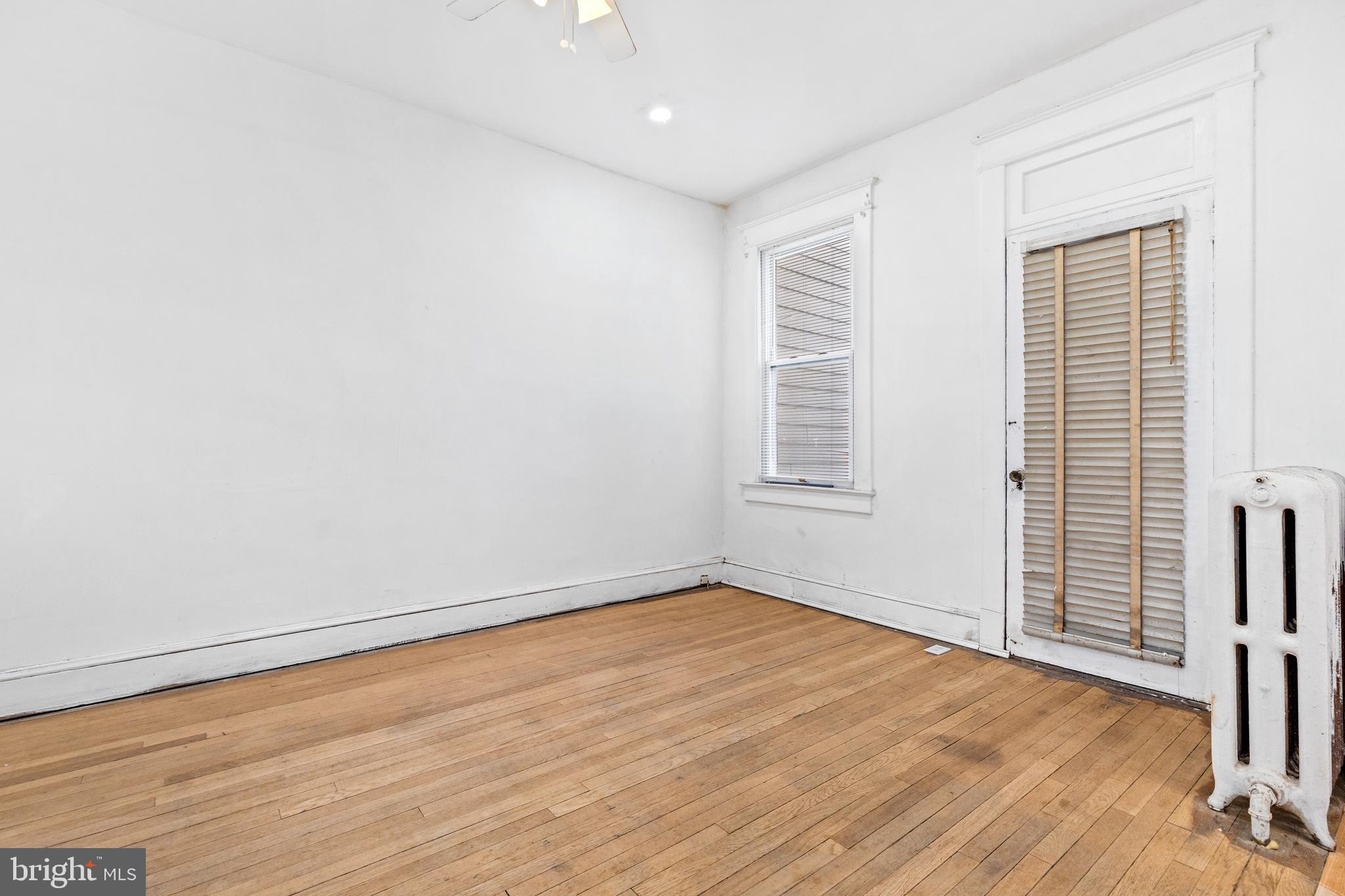 5506 8th Street Northwest Washington, DC 20011 - Photo 12 of 26 wooden floor in an empty room with a window