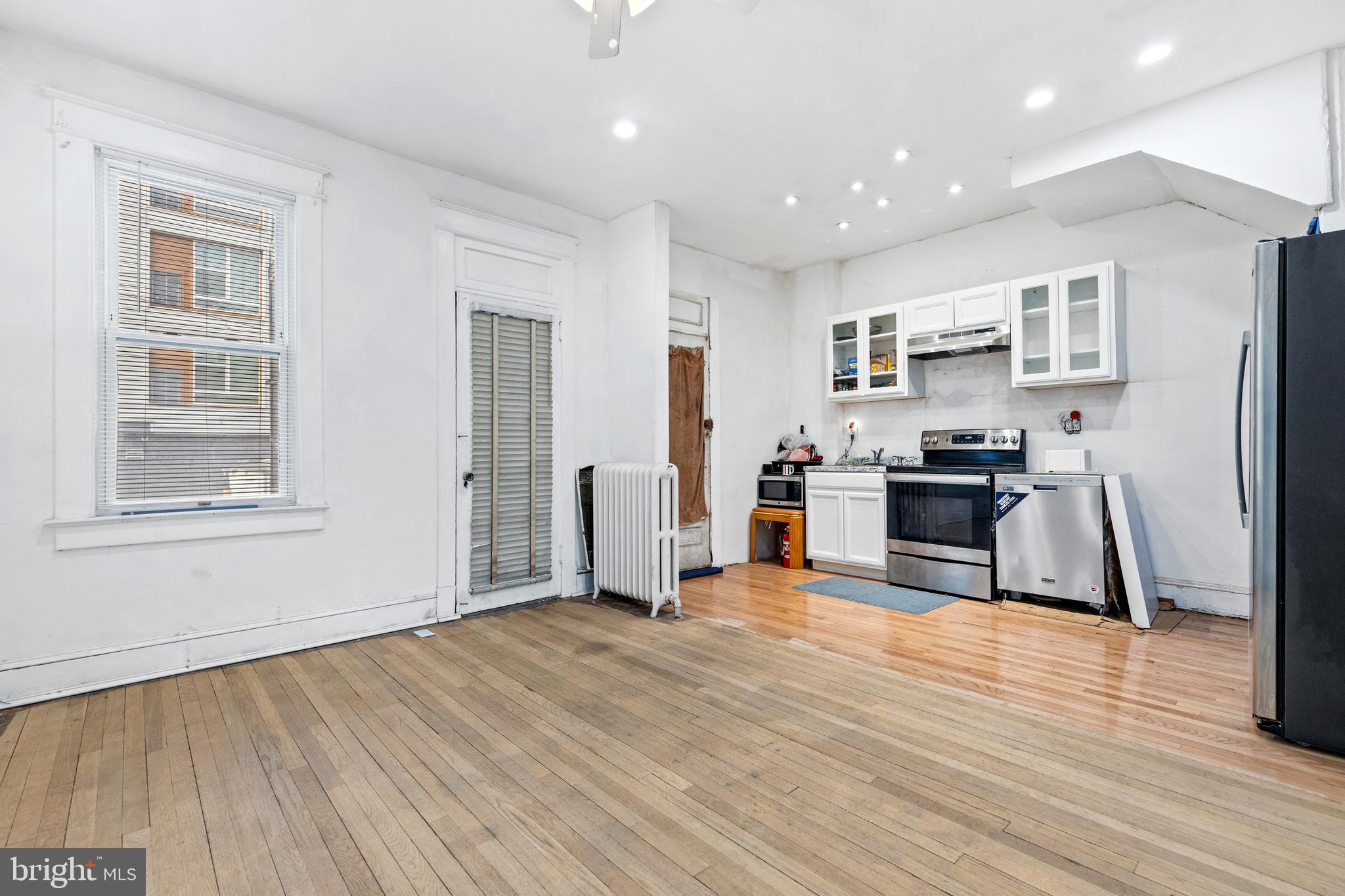 5506 8th Street Northwest Washington, DC 20011 - Photo 14 of 26 a kitchen with stainless steel appliances wooden floor and a refrigerator