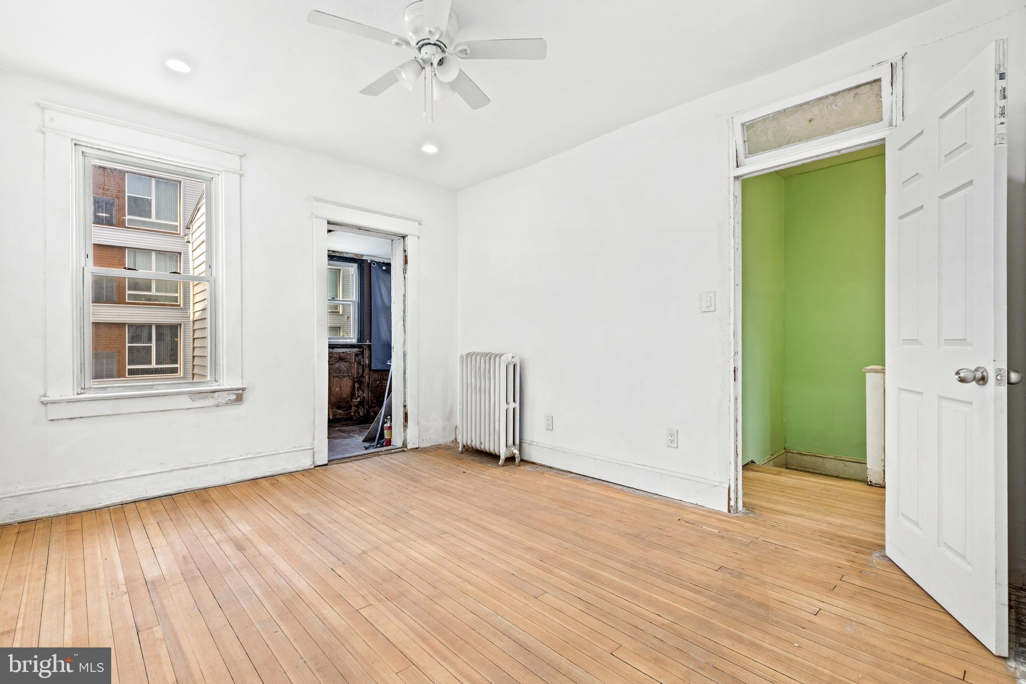 5506 8th Street Northwest Washington, DC 20011 - Photo 16 of 26 a view of an empty room with wooden floor and a window