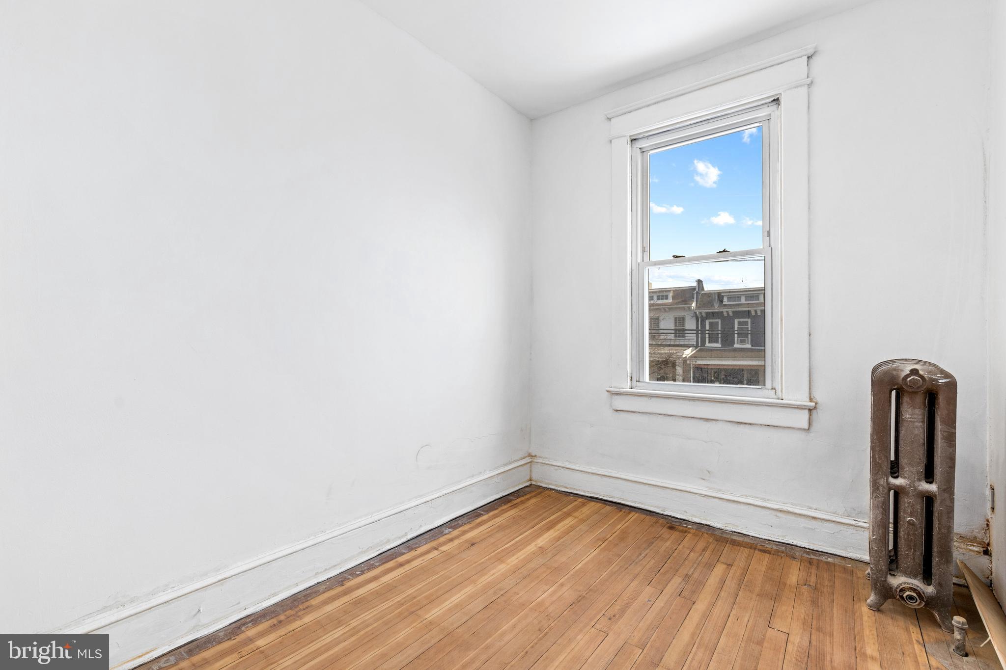 5506 8th Street Northwest Washington, DC 20011 - Photo 22 of 26 an empty room with wooden floor and a window