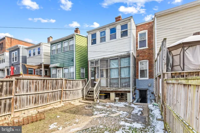 a view of a house with wooden fence