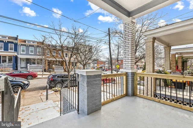 a view of a porch with a table and chairs