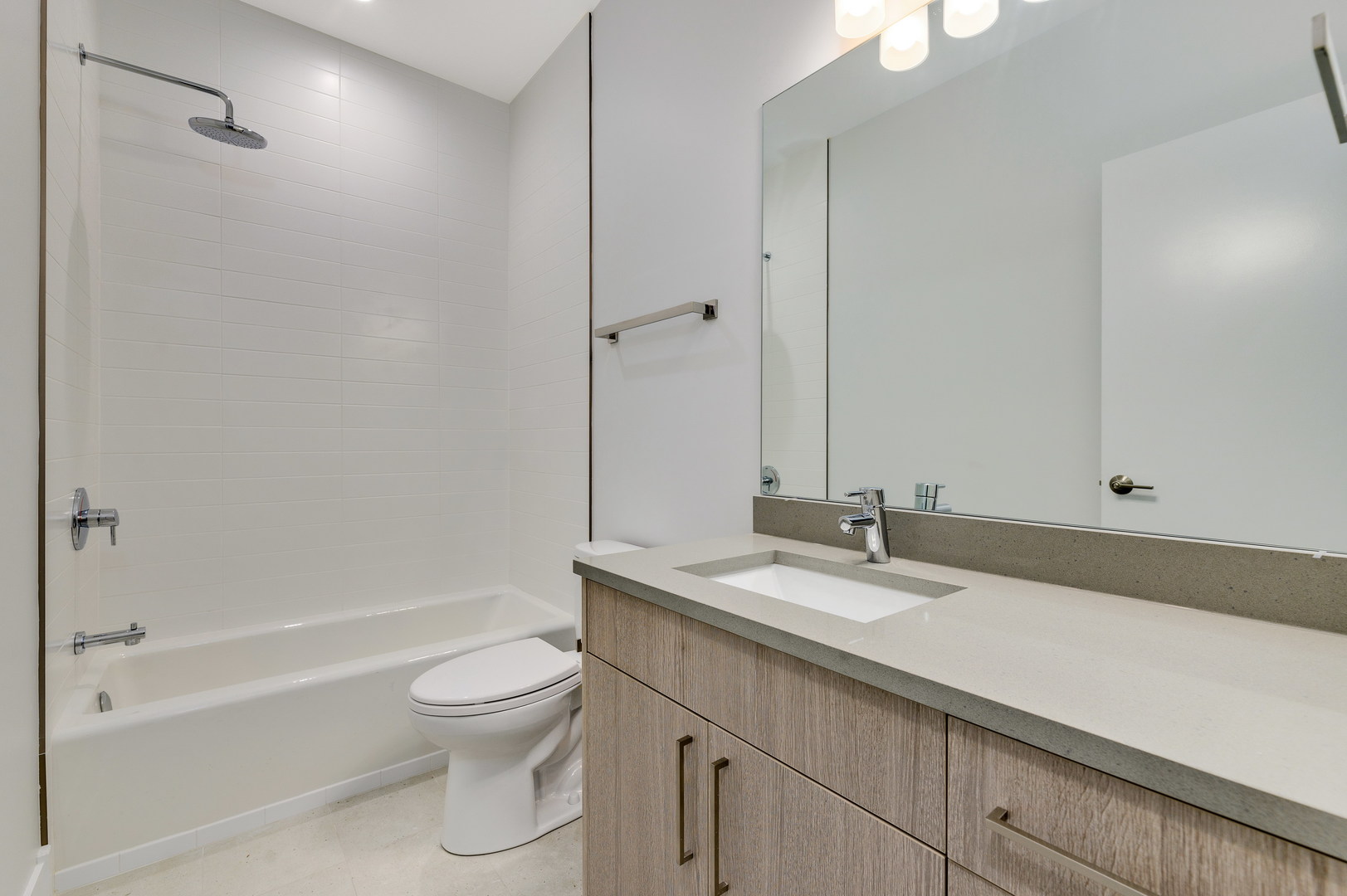 1807 West Division Street, Unit 301 Chicago, IL 60622 - Photo 12 of 15 a bathroom with a granite countertop sink a toilet and shower