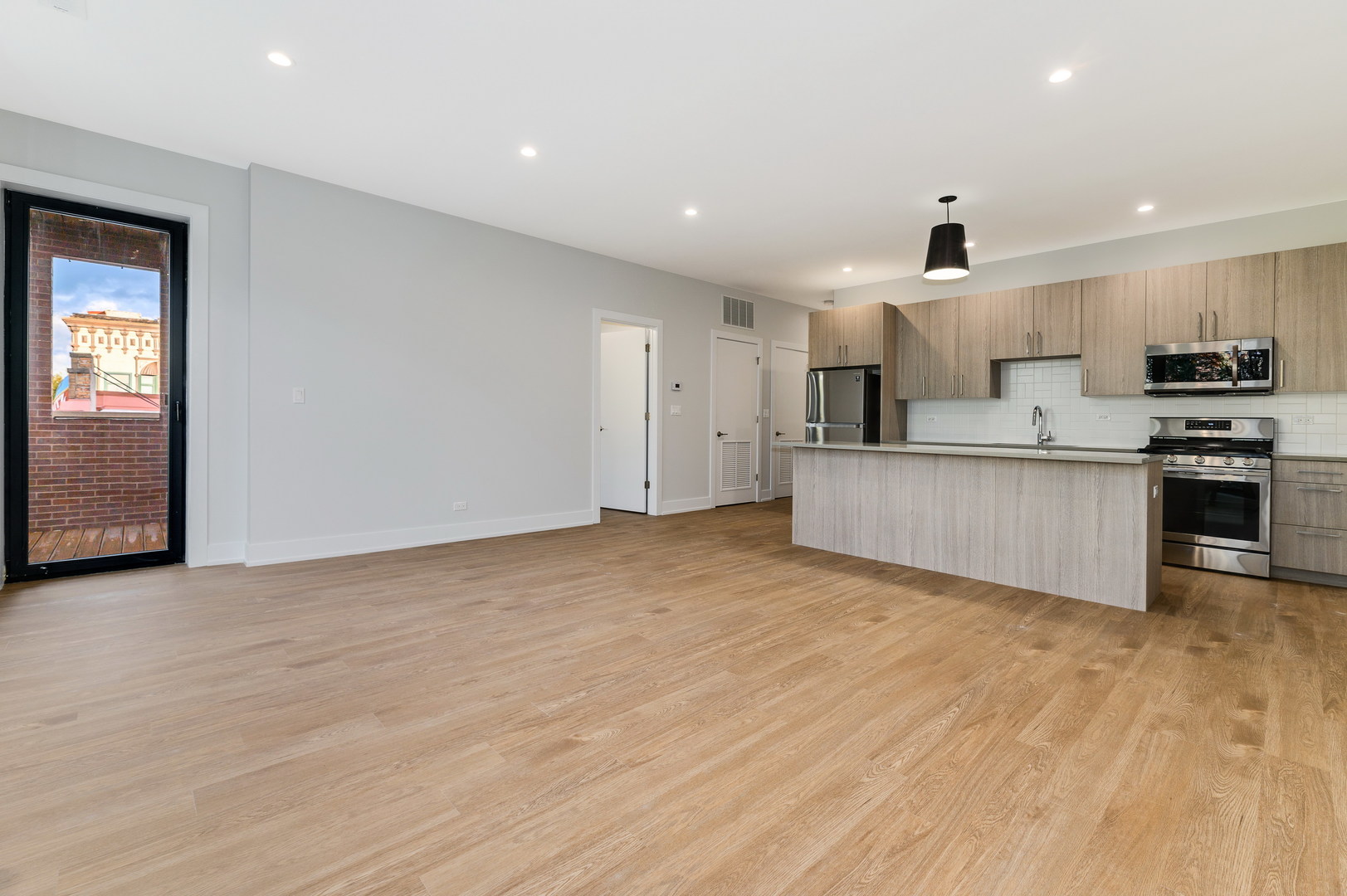 1807 West Division Street, Unit 301 Chicago, IL 60622 - Photo 3 of 15 a view of kitchen with wooden floor and electronic appliances
