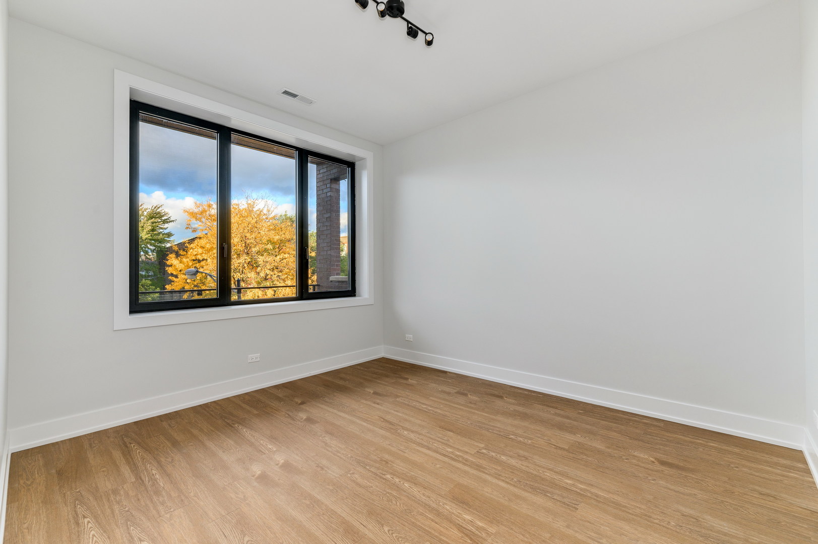 1807 West Division Street, Unit 301 Chicago, IL 60622 - Photo 8 of 15 wooden floor in an empty room with a window