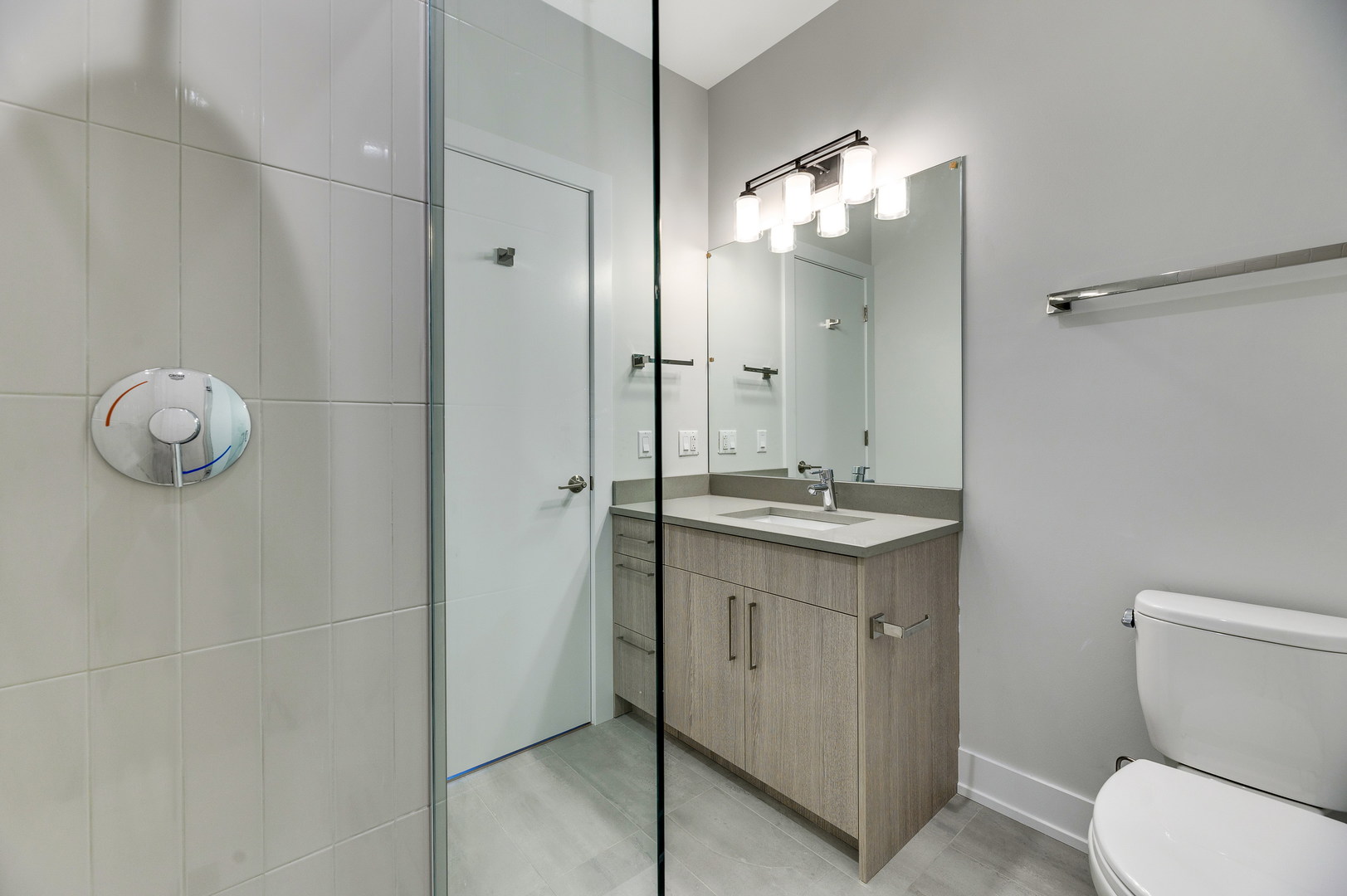 1807 West Division Street, Unit 301 Chicago, IL 60622 - Photo 10 of 15 a bathroom with a sink a toilet and mirror