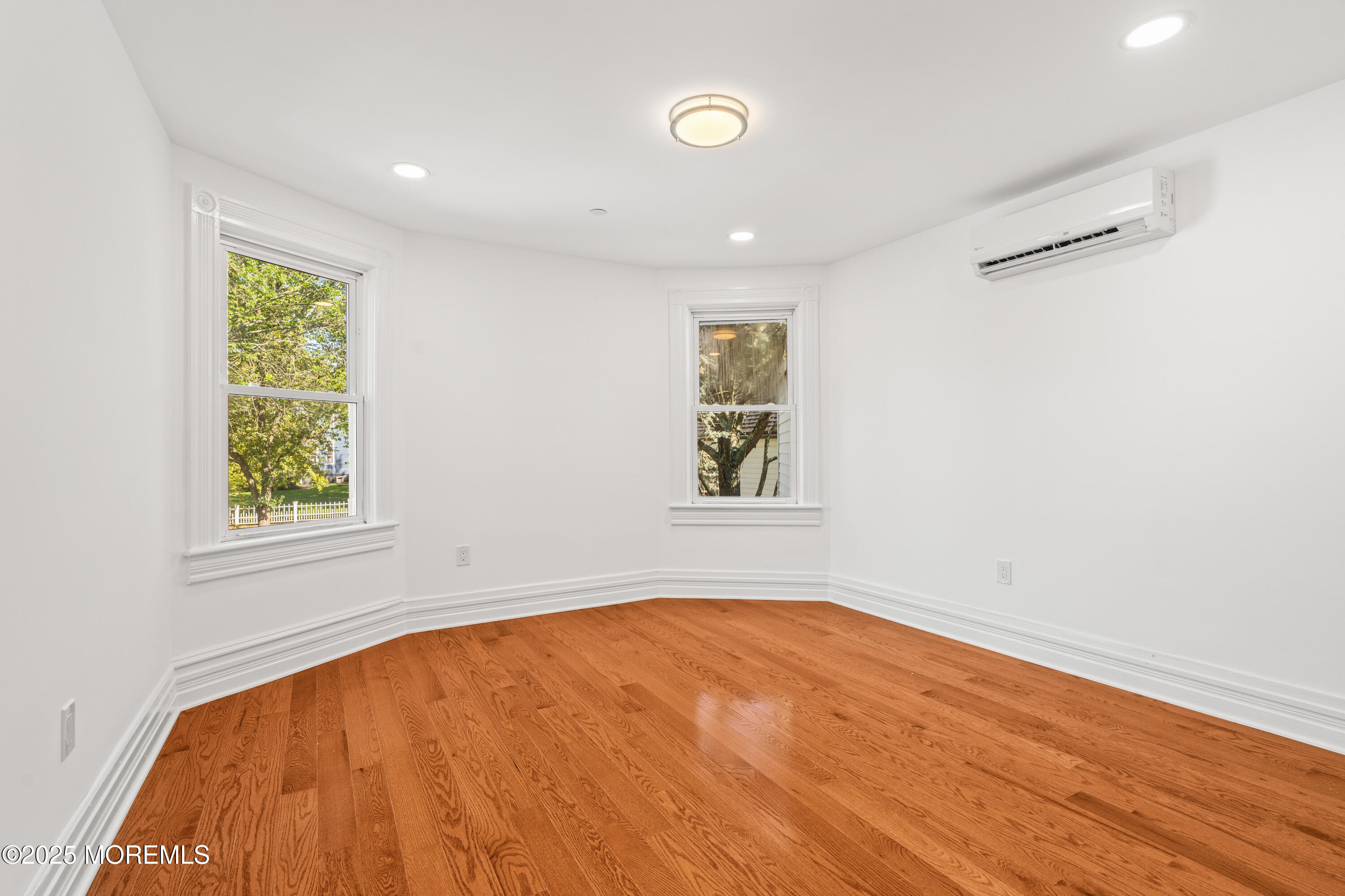 73 3rd Avenue, Unit C Atlantic Highlands, NJ 07716 - Photo 16 of 21 an empty room with a window and wooden floor