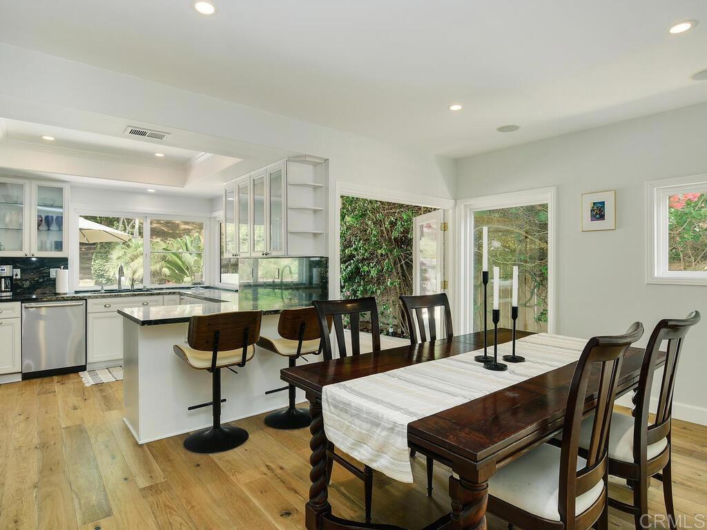 14146 Mango Drive Del Mar, CA 92014 - Photo 13 of 33 a view of a dining room with furniture window and wooden floor