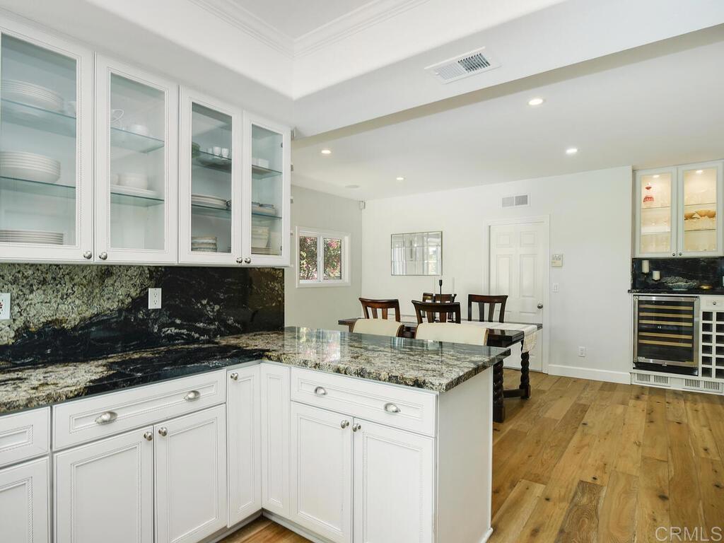 14146 Mango Drive Del Mar, CA 92014 - Photo 16 of 33 a kitchen with granite countertop a sink and a stove top oven