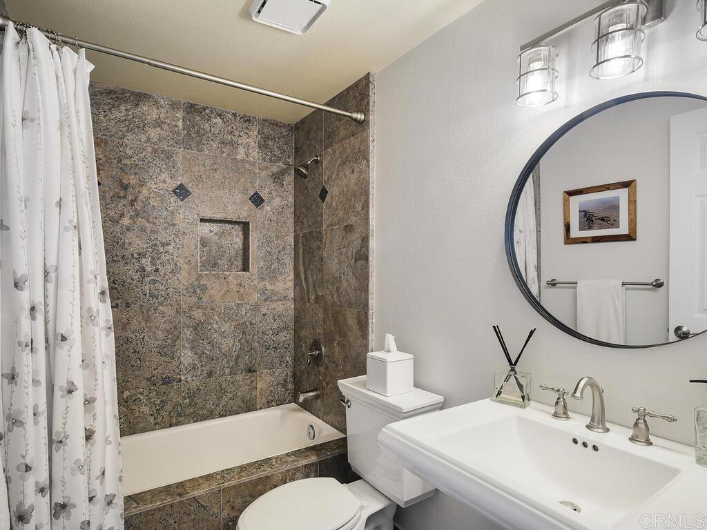 14146 Mango Drive Del Mar, CA 92014 - Photo 20 of 33 a bathroom with a sink and a mirror