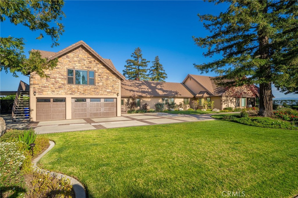 a view of a house with a big yard and potted plants