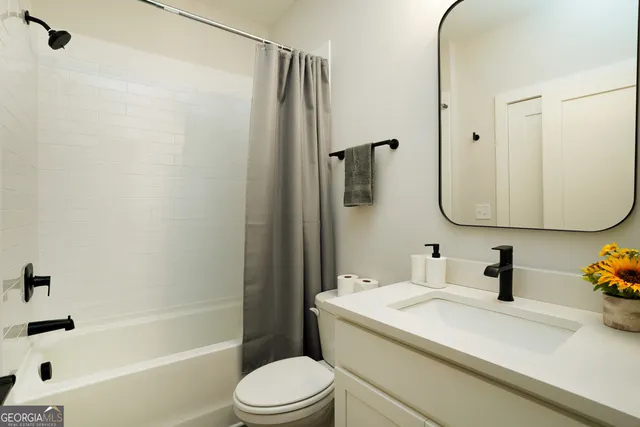 a bathroom with a shower a toilet and sink