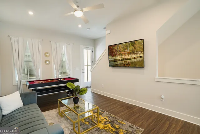 a living room with furniture and wooden floor
