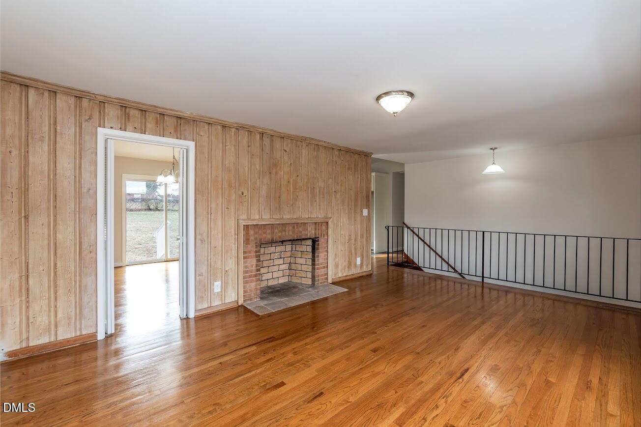 4000 Donna Road Raleigh, NC 27604 - Photo 20 of 58 an empty room with wooden floor fireplace and windows