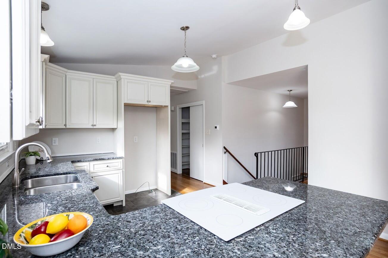 4000 Donna Road Raleigh, NC 27604 - Photo 22 of 58 a kitchen with a sink a stove and cabinets