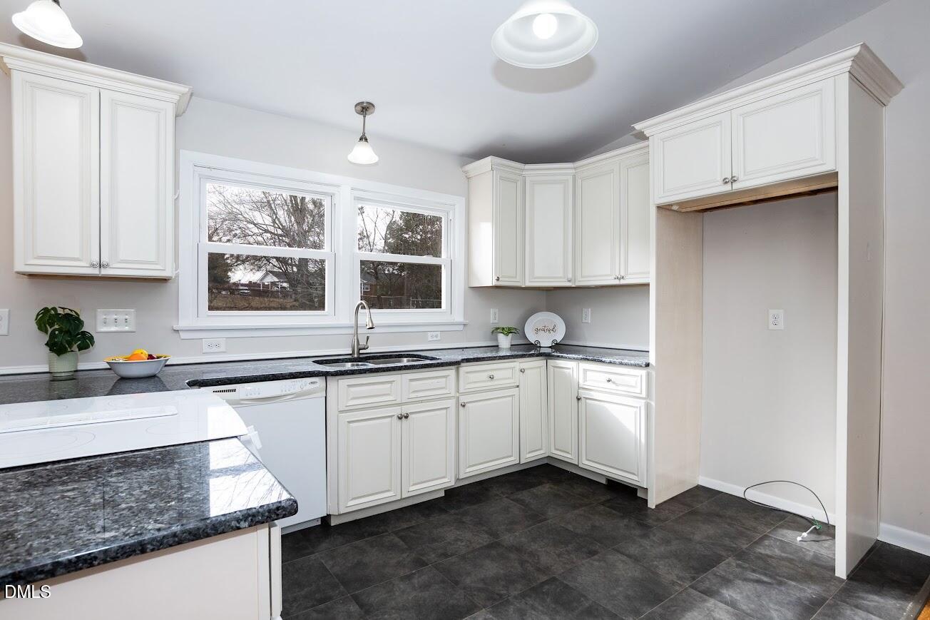 4000 Donna Road Raleigh, NC 27604 - Photo 24 of 58 a kitchen with stainless steel appliances granite countertop a sink stove and cabinets