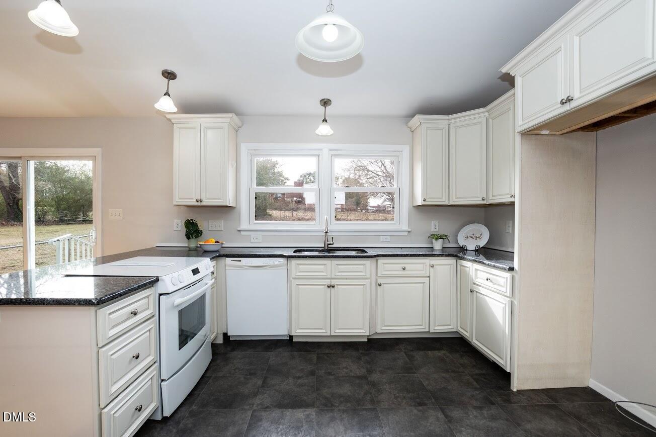 4000 Donna Road Raleigh, NC 27604 - Photo 25 of 58 a kitchen with a sink stove and cabinets