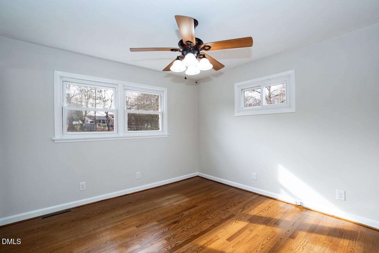 4000 Donna Road Raleigh, NC 27604 - Photo 35 of 58 a view of an empty room with wooden floor and a window