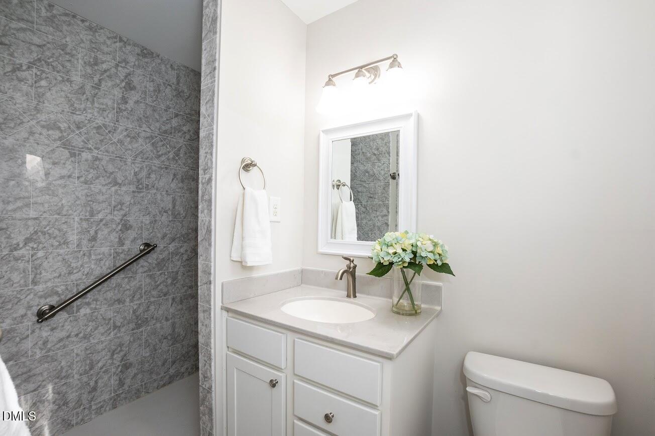 4000 Donna Road Raleigh, NC 27604 - Photo 38 of 58 a bathroom with a sink a toilet and a mirror