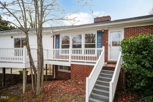 a view of a kitchen with wooden floor and a window