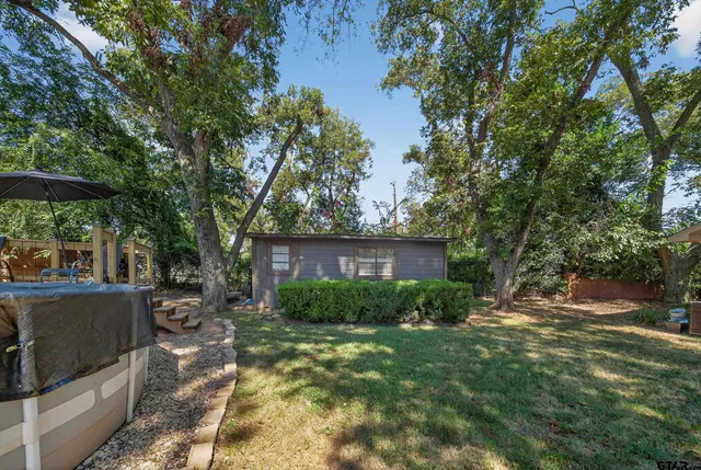 a view of backyard with outdoor seating and green space