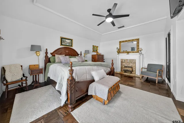 a bedroom with a bed a couch and a chandelier