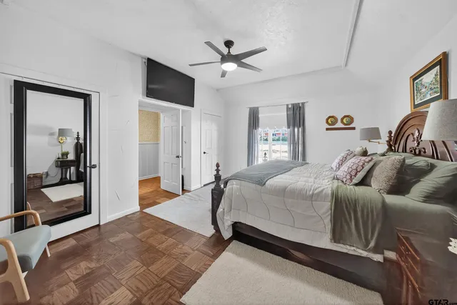 a bedroom with a large bed and a chandelier