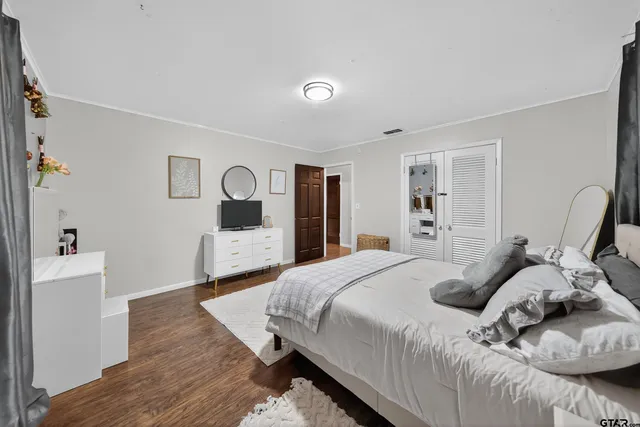 a bedroom with a bed and a dresser