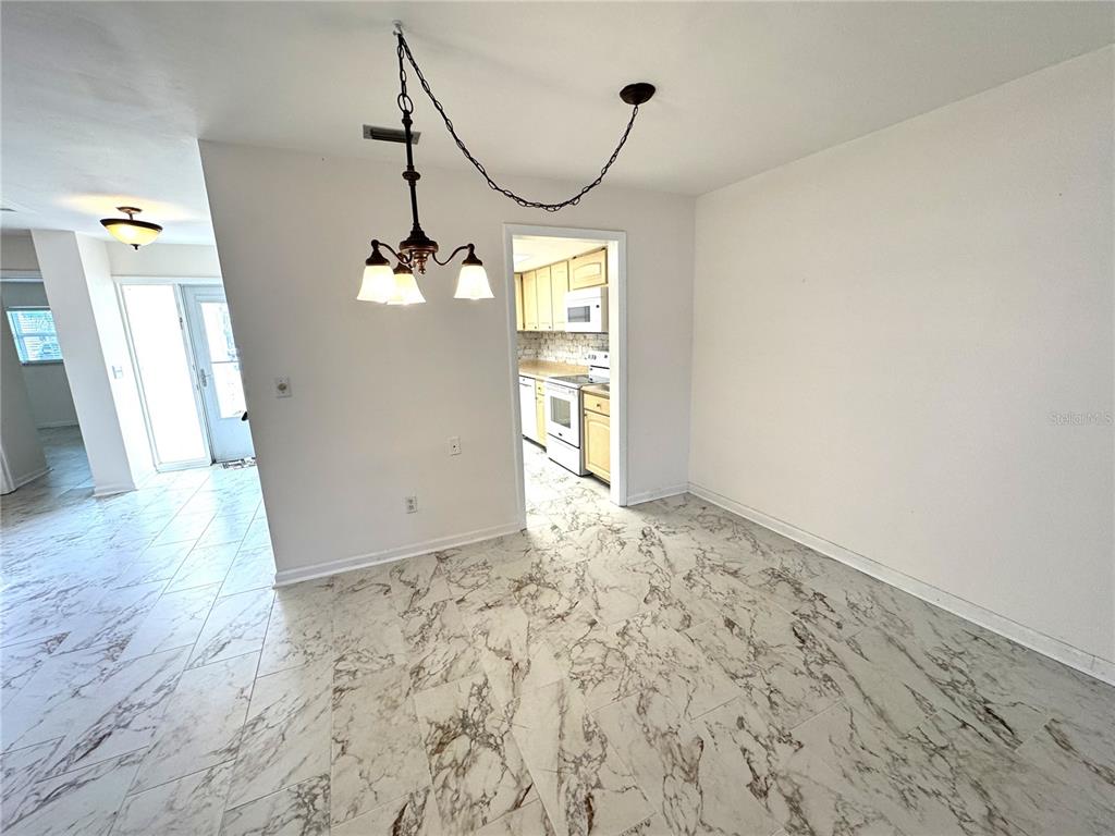 610 Indian Rocks Road North, Unit 103 Belleair Bluffs, FL 33770 - Photo 5 of 13 a view of a livingroom with wooden floor and stairs