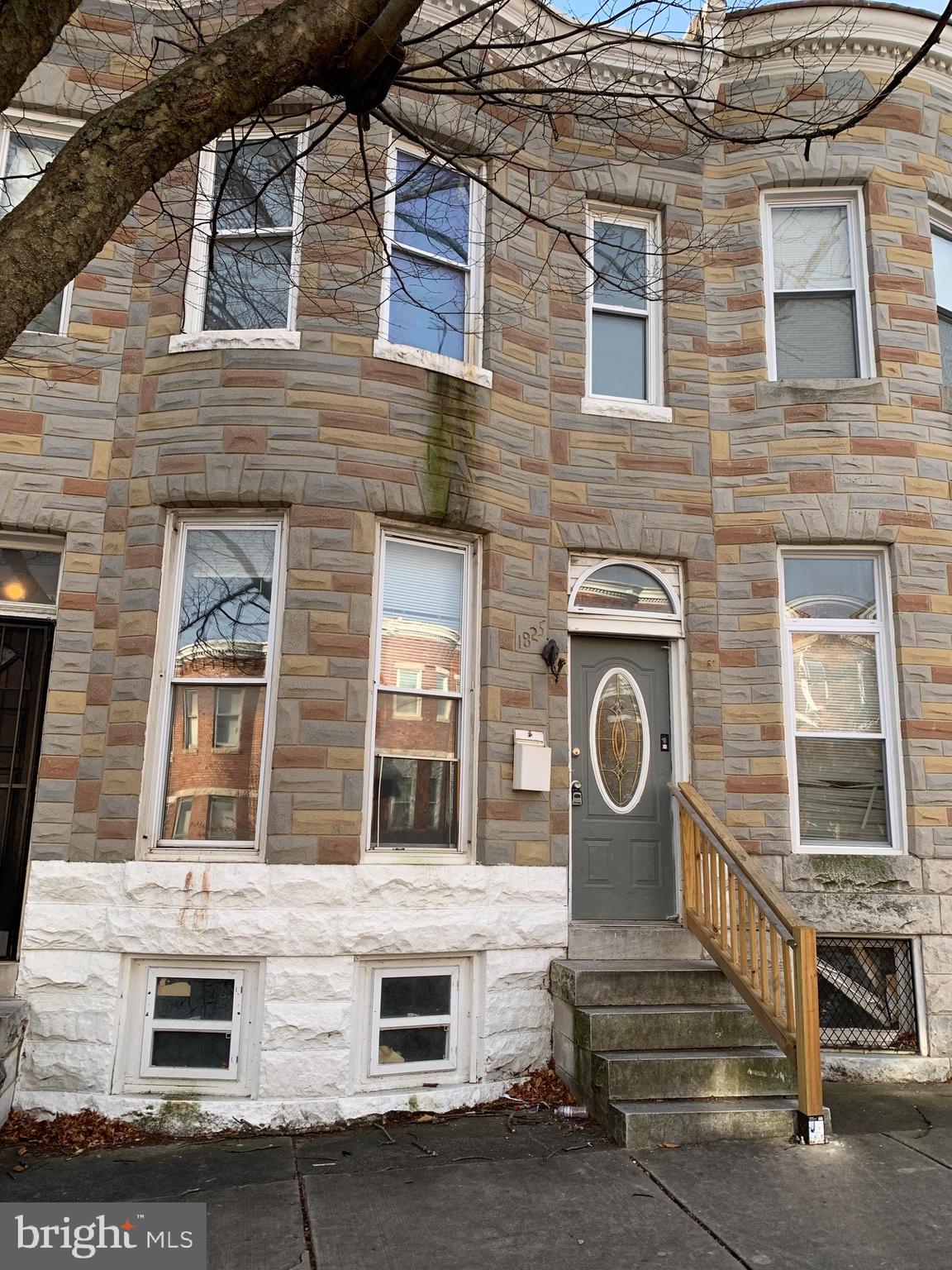 1825 Walbrook Avenue Baltimore, MD 21217 - Photo 1 of 13 a front view of a house with stairs