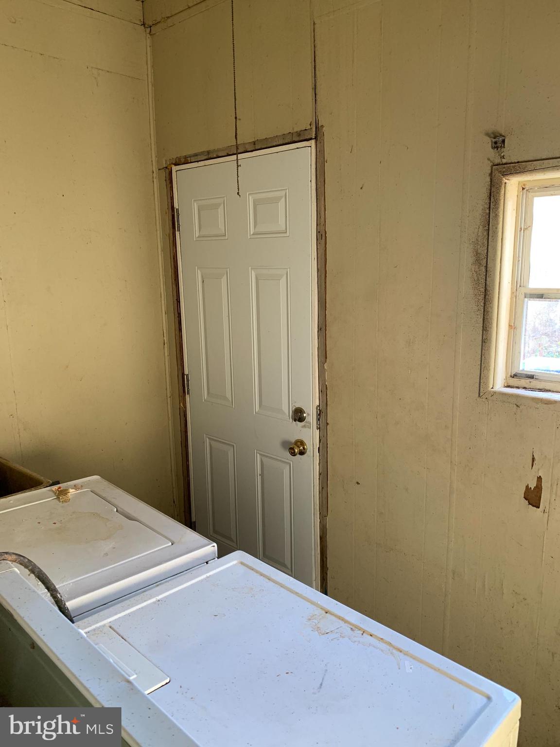 1825 Walbrook Avenue Baltimore, MD 21217 - Photo 4 of 13 a bedroom with a bed and a window