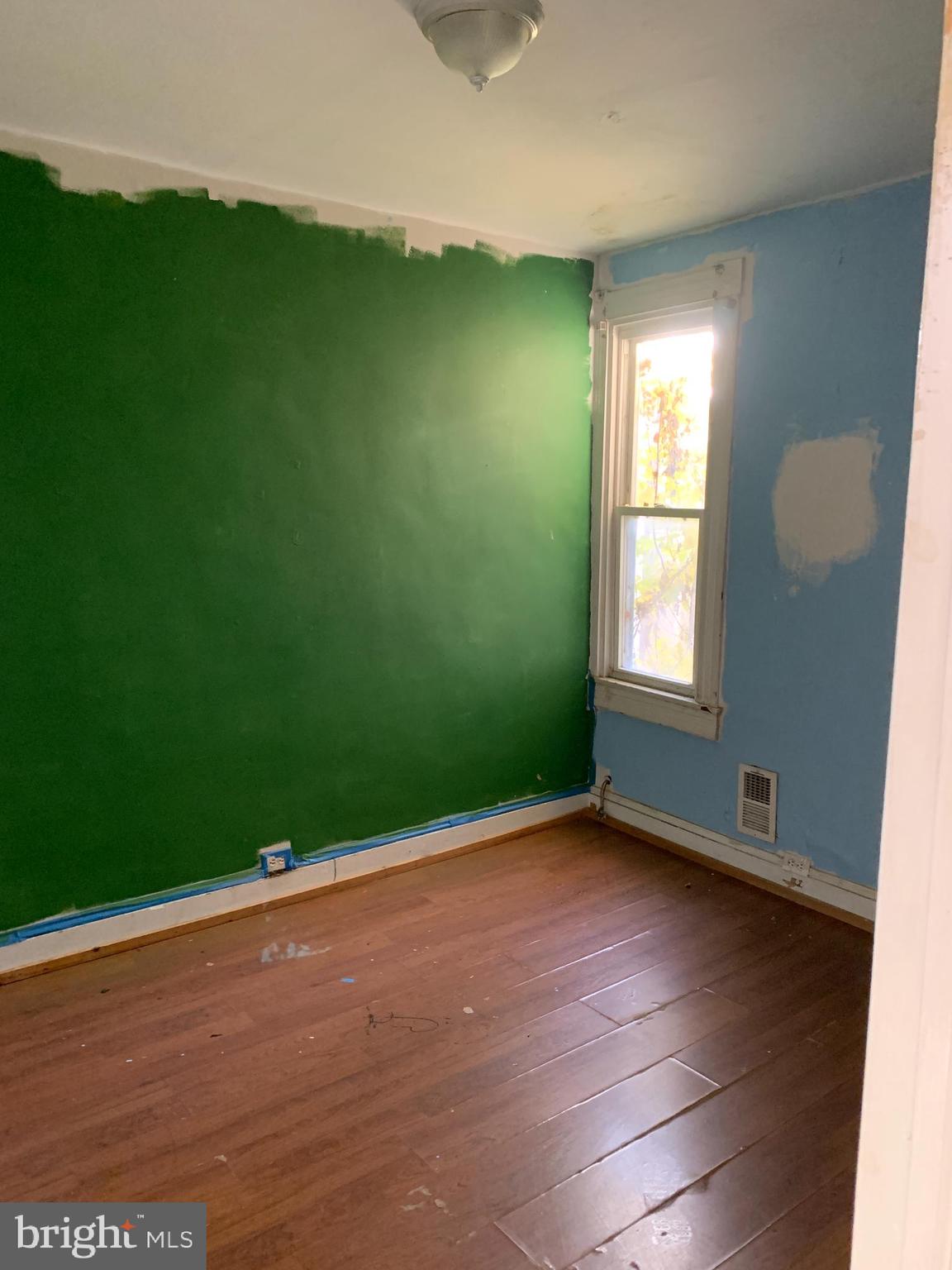 1825 Walbrook Avenue Baltimore, MD 21217 - Photo 7 of 13 an empty room with windows