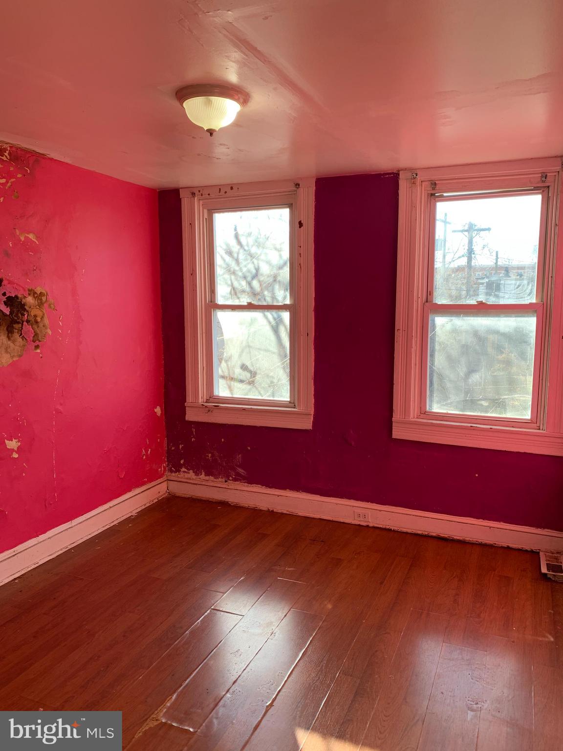 1825 Walbrook Avenue Baltimore, MD 21217 - Photo 9 of 13 a view of an empty room with wooden floor and a window