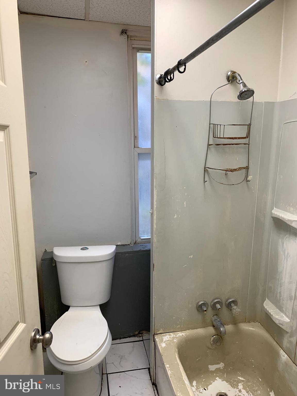 1825 Walbrook Avenue Baltimore, MD 21217 - Photo 10 of 13 a white toilet sitting next to a bathroom sink and tub